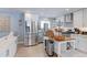 Well-lit kitchen with stainless steel appliances, white cabinets, a butcher block island, and tiled backsplash at 7966 Ingalls St, Arvada, CO 80003