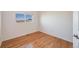 Simple bedroom with hardwood floors and a window at 410 Smith Cir, Erie, CO 80516