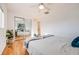 Well-lit bedroom with mirrored closet and hardwood floors at 410 Smith Cir, Erie, CO 80516