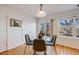 Bright dining area with glass table and access to backyard at 410 Smith Cir, Erie, CO 80516