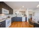 Updated kitchen featuring dark cabinetry and hardwood floors at 410 Smith Cir, Erie, CO 80516