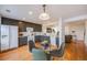 Eat-in kitchen with dark cabinetry and a glass dining table at 410 Smith Cir, Erie, CO 80516