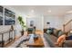 Open living room featuring hardwood floors and ample natural light at 410 Smith Cir, Erie, CO 80516