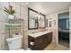 Bathroom with dual sinks, a large mirror, and tile walls, offering a relaxing space at 5745 W Atlantic Pl # 104, Lakewood, CO 80227