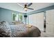 Bedroom featuring a ceiling fan, large window, and spacious closet with sliding doors at 5745 W Atlantic Pl # 104, Lakewood, CO 80227