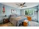 Comfortable bedroom with large window, ceiling fan, and cozy furnishings for a relaxing retreat at 5745 W Atlantic Pl # 104, Lakewood, CO 80227