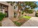 Townhome with a neatly kept lawn and mature trees offering shade and curb appeal at 5745 W Atlantic Pl # 104, Lakewood, CO 80227
