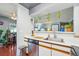 Bright kitchen featuring stainless steel appliances, white countertops, and view to the living room at 5745 W Atlantic Pl # 104, Lakewood, CO 80227