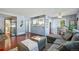 Cozy living room with gray sectional, hardwood floors, and a pass-through to the kitchen at 5745 W Atlantic Pl # 104, Lakewood, CO 80227