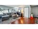 Comfortable living room featuring a gray sectional sofa, front door, and hardwood flooring at 5745 W Atlantic Pl # 104, Lakewood, CO 80227