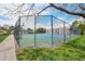 View of the community tennis courts surrounded by a fence and landscaping at 5745 W Atlantic Pl # 104, Lakewood, CO 80227