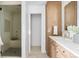 Modern bathroom features marble counters, wood cabinets, glass shower, and clean design at 6686 E Jamison Ave, Centennial, CO 80112