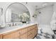 Bright bathroom featuring double sink vanity, stylish mirrors, tile floors, and modern fixtures at 6686 E Jamison Ave, Centennial, CO 80112