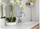Bathroom featuring marble countertops, white cabinets, and a large mirror with decorative flowers at 6686 E Jamison Ave, Centennial, CO 80112