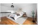 Comfortable bedroom with modern decor, neutral tones and hardwood flooring at 6686 E Jamison Ave, Centennial, CO 80112