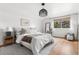 Spacious bedroom with stylish light fixture, neutral decor, and bright window at 6686 E Jamison Ave, Centennial, CO 80112