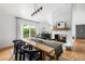 Bright dining room features a fireplace, wood floors, sliding doors to backyard, and modern lighting at 6686 E Jamison Ave, Centennial, CO 80112