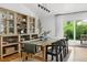 Open dining room with hardwood floors, built in cabinetry, modern lighting and access to the outdoors at 6686 E Jamison Ave, Centennial, CO 80112