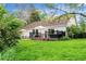 Exterior of a house with a deck, a patio, a grassy yard, and mature trees at 6686 E Jamison Ave, Centennial, CO 80112