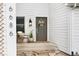 Charming covered front porch with decorative wreath on the front door and exterior decor at 6686 E Jamison Ave, Centennial, CO 80112