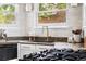 Modern kitchen with granite countertops, gold faucet, tile backsplash, and stainless steel appliances at 6686 E Jamison Ave, Centennial, CO 80112