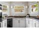 Bright kitchen features granite counters, white cabinets, modern fixtures and stainless steel appliances at 6686 E Jamison Ave, Centennial, CO 80112