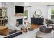 Cozy living room featuring a fireplace with a mounted TV and an adjacent dining area at 6686 E Jamison Ave, Centennial, CO 80112