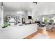 Bright, open-concept living room with hardwood floors, white brick fireplace and modern furnishings at 6686 E Jamison Ave, Centennial, CO 80112