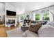 Bright, open living room with hardwood floors, fireplace, stylish furnishings, and lots of natural light at 6686 E Jamison Ave, Centennial, CO 80112