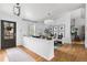 Bright, open-concept living room with hardwood floors, a modern decor, and a partial wall at 6686 E Jamison Ave, Centennial, CO 80112