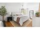 Bright primary bedroom with wood floors, natural light and modern decor at 6686 E Jamison Ave, Centennial, CO 80112