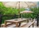 Back deck featuring an outdoor dining table with an umbrella and lounge chairs at 6686 E Jamison Ave, Centennial, CO 80112