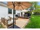 Relaxing patio area with stylish furniture, gas grill, fire pit, and lush greenery surrounding the space at 6686 E Jamison Ave, Centennial, CO 80112