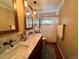 Bathroom with double sinks, marble countertops, and a shower/tub with white curtain at 85 S Sherwood Gln, Monument, CO 80132
