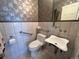 Cozy bathroom with uniquely patterned walls, modern toilet, and pedestal sink at 85 S Sherwood Gln, Monument, CO 80132