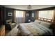 Comfortable bedroom with a decorative bedspread, plush rug, and chair near sunlit windows at 85 S Sherwood Gln, Monument, CO 80132