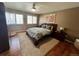 Bedroom featuring neutral tones, hardwood floors, a ceiling fan and large windows at 85 S Sherwood Gln, Monument, CO 80132