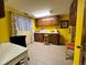 Bright bonus room with wooden cabinets, charming curtains and a mix of seating options at 85 S Sherwood Gln, Monument, CO 80132