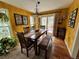 Welcoming dining room featuring a wooden table, bench seating, and a sliding glass door to outside at 85 S Sherwood Gln, Monument, CO 80132