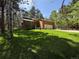 Lovely exterior featuring a two-car garage, complemented by a well-maintained lawn and towering trees at 85 S Sherwood Gln, Monument, CO 80132