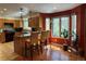 Open kitchen area with bar seating and scenic views from surrounding windows at 85 S Sherwood Gln, Monument, CO 80132