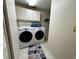 Efficient laundry room featuring a washer, dryer, storage cabinets and shelving unit at 85 S Sherwood Gln, Monument, CO 80132