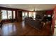 Spacious living room with hardwood floors, a brick fireplace, and large windows at 85 S Sherwood Gln, Monument, CO 80132