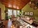 Bright and airy living room with wood ceiling, complemented by lush plants and natural light at 85 S Sherwood Gln, Monument, CO 80132