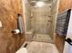 Modern tiled shower with glass door and a built-in seating area and wall-mounted shelves at 85 S Sherwood Gln, Monument, CO 80132
