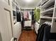 Organized walk-in closet with built-in shelving, drawers, and ample hanging space at 85 S Sherwood Gln, Monument, CO 80132