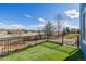 Backyard with artificial grass and iron fence at 8802 E 148Th Ln, Thornton, CO 80602