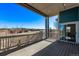 Covered balcony with wood flooring, railing, and views of the neighborhood at 8802 E 148Th Ln, Thornton, CO 80602