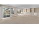 Expansive basement with built-in storage, large windows, and sliding glass doors at 8802 E 148Th Ln, Thornton, CO 80602