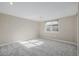 Bright bedroom featuring neutral walls, soft carpet, and a window allowing natural light to fill the space at 8802 E 148Th Ln, Thornton, CO 80602